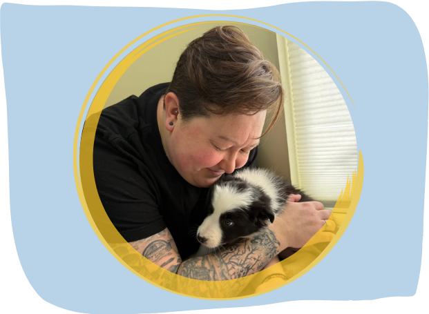 vet staff hugging a puppy